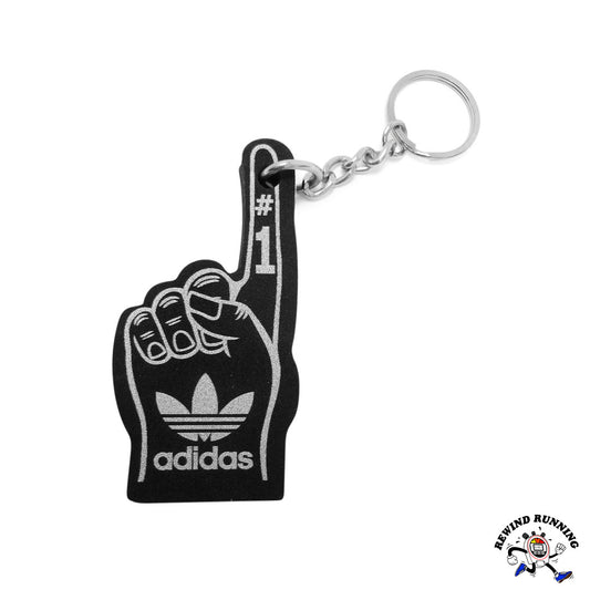 Black foam finger keychain with Adidas logo on a white background