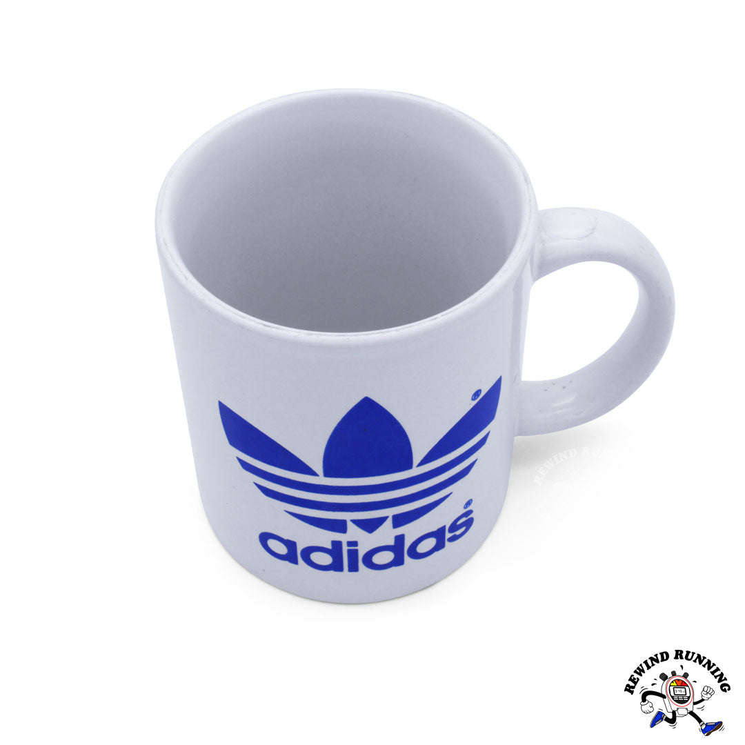 Vintage adidas Trefoil Logo 12 oz ceramic coffee mug. White with blue adidas logo. Top view