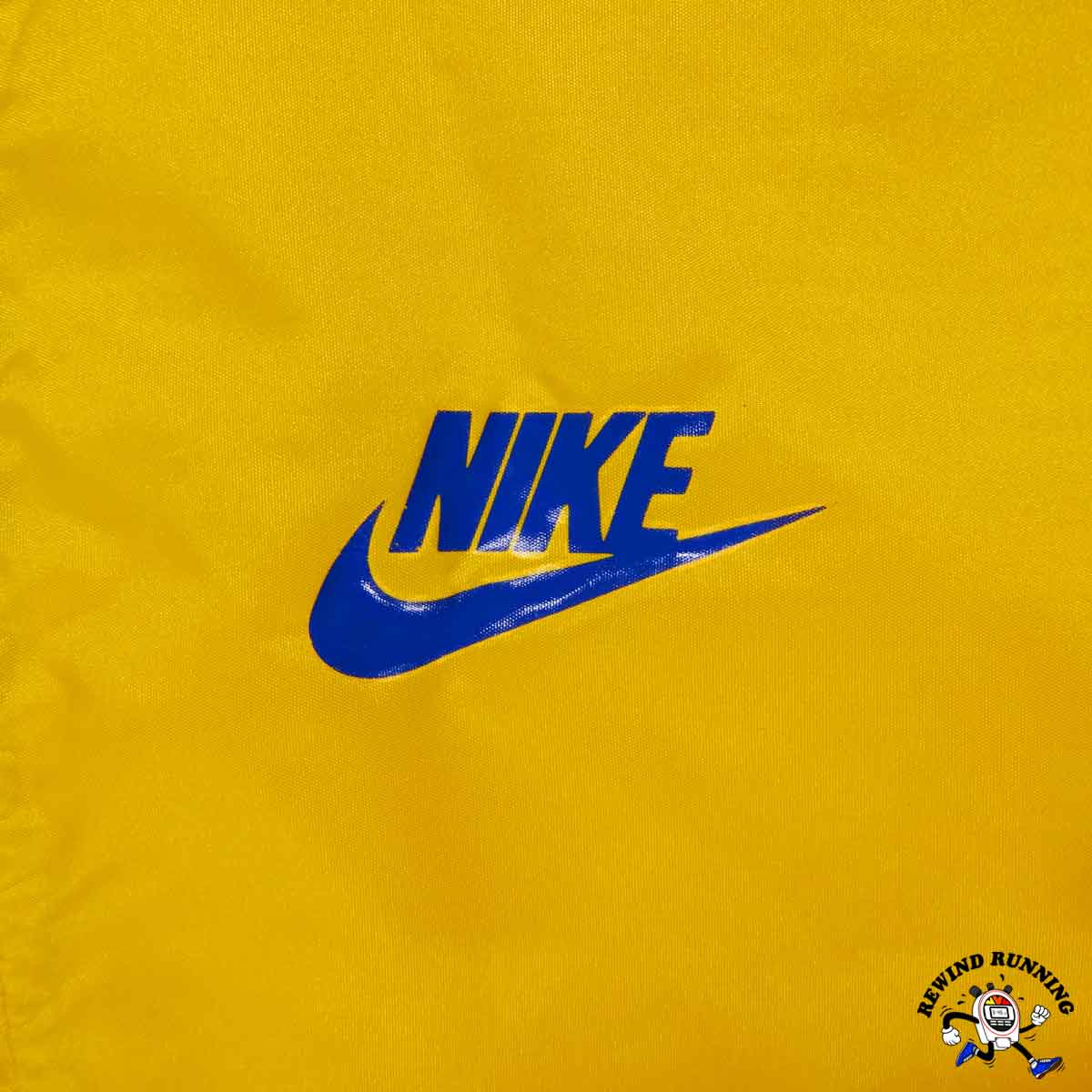 Blue Nike logo on a yellow background