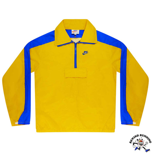 Yellow and blue vintage 70s pullover windbreaker with Nike logo on a white background