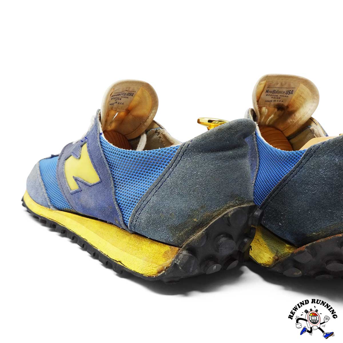 New Balance Blue Yellow 355 Vintage 1970s Sneakers running shoes with worn soles on a white background, featuring a brand logo.