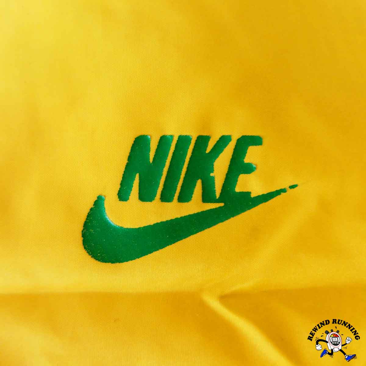 Green Nike logo on a yellow background