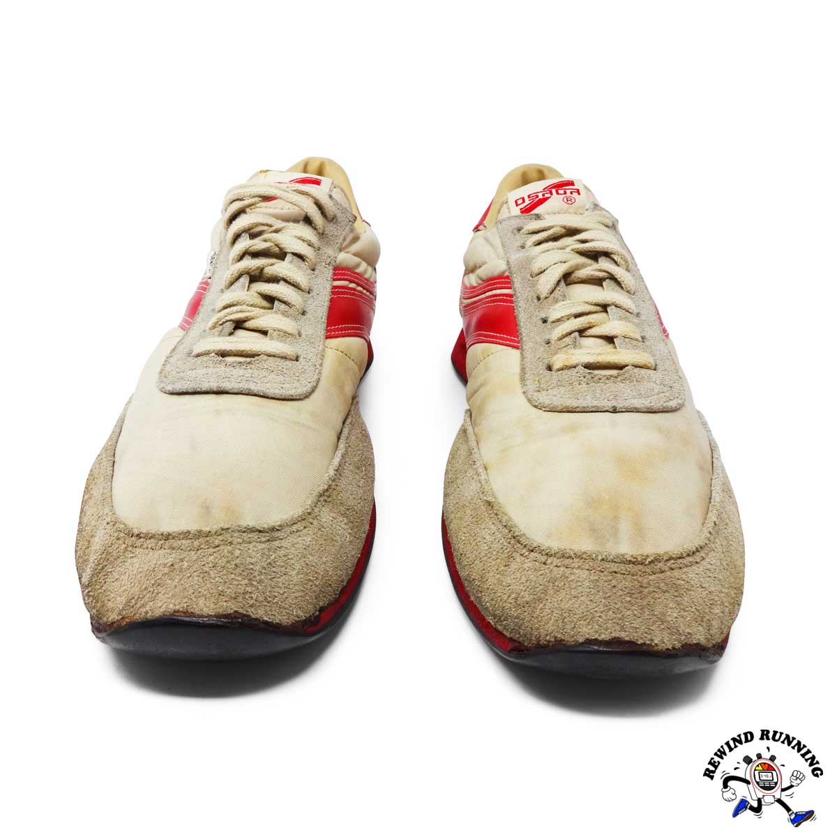 Pair of vintage running shoes with red accents on a white background