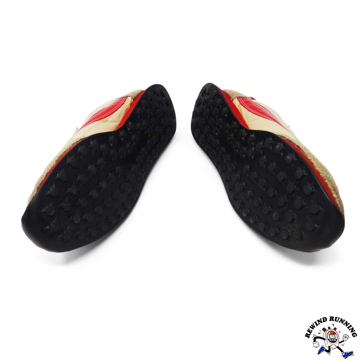 Black sole pads with red and beige accents on a white background