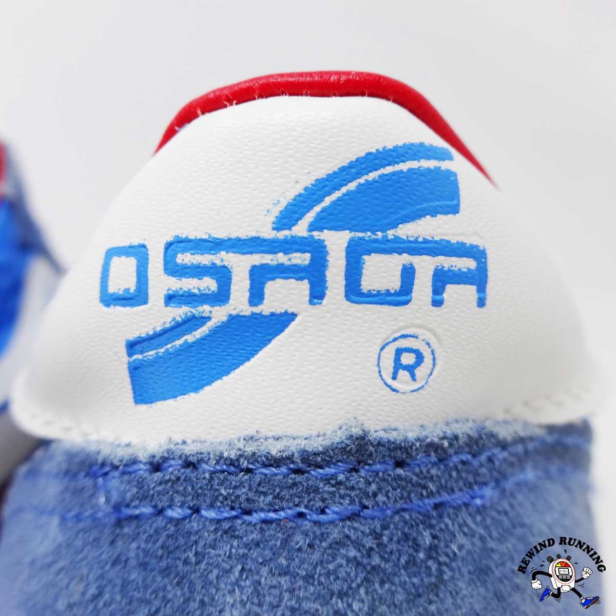 Close-up of a sneaker with a blue and red Osaga logo on a white background