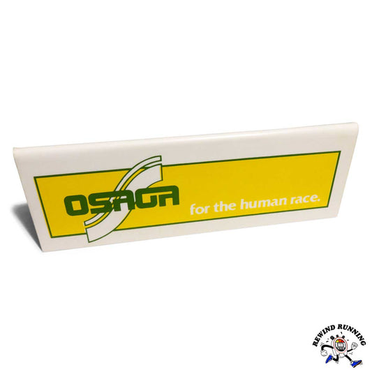 Rectangular Osaga sign with yellow background and green text on a white background